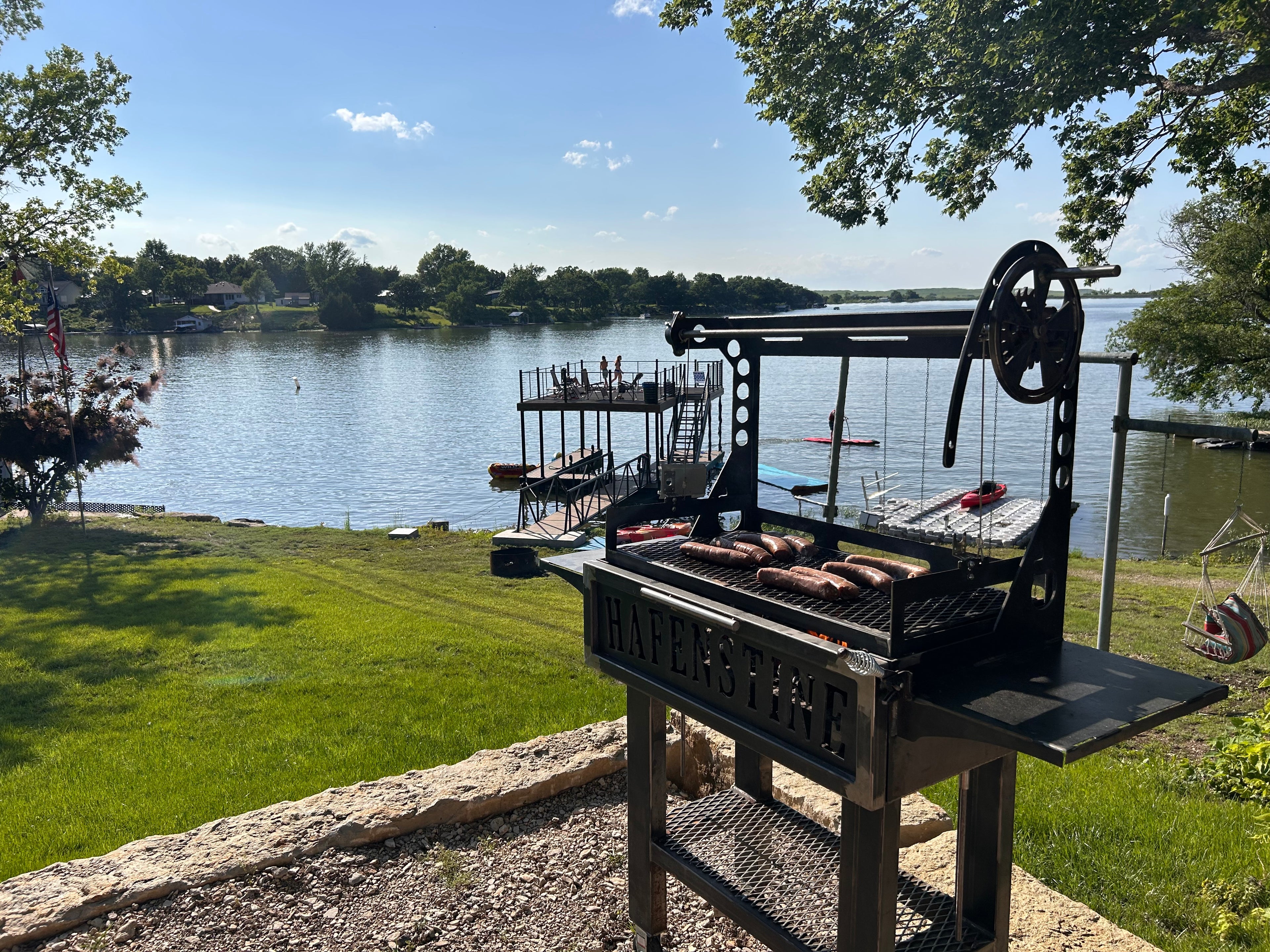 Outdoor grill setup with a scenic lake view