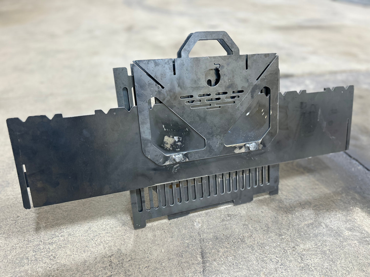 Black metal tool or device on a gray surface