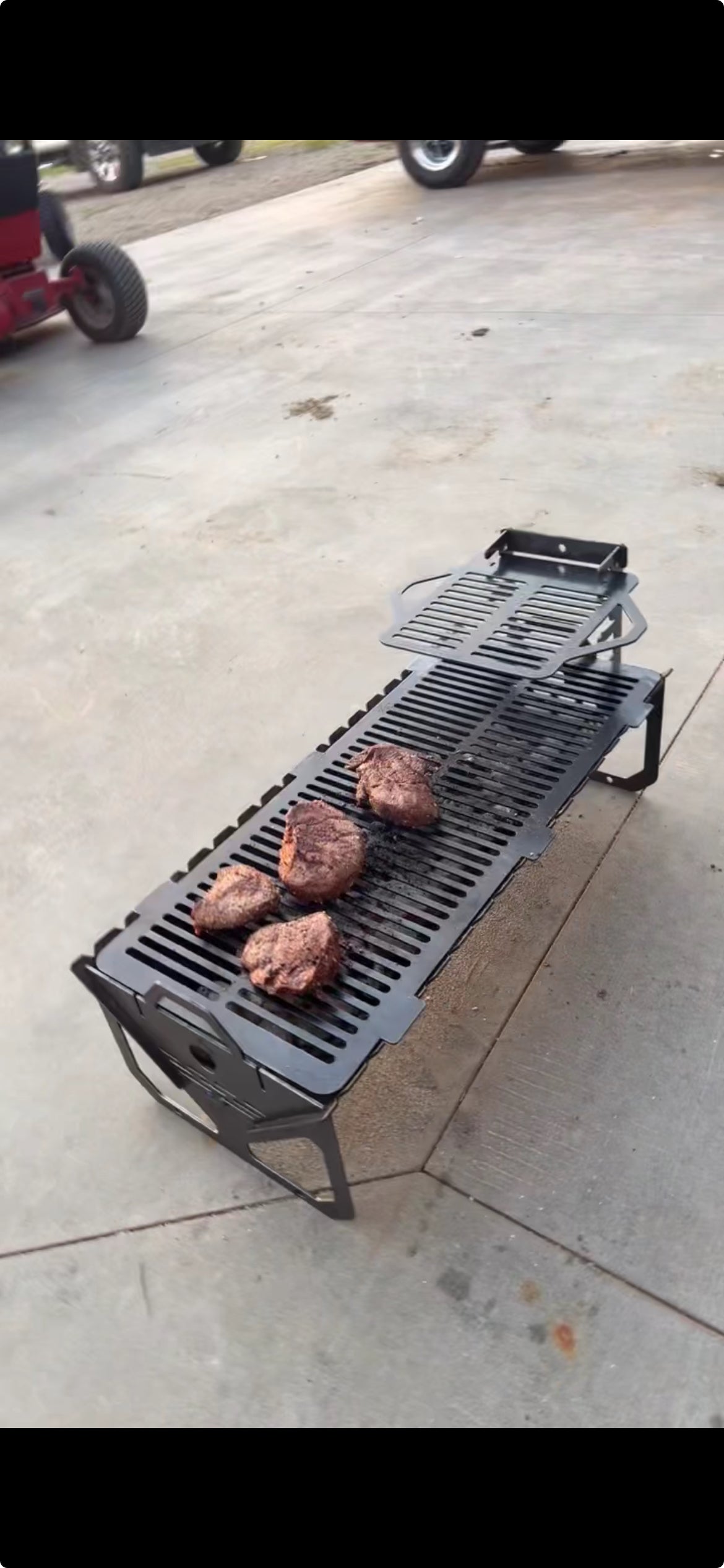 Grill with food on a concrete surface