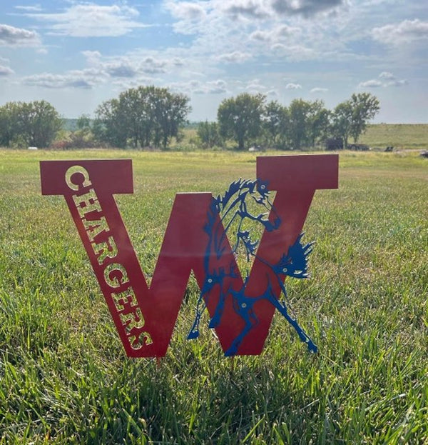Red 'W' with 'Chargers' text on grass against a blue sky