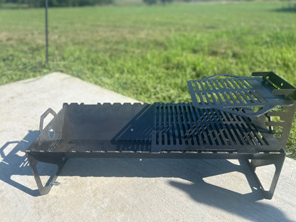 Black metal grill on a concrete surface with grass in the background
